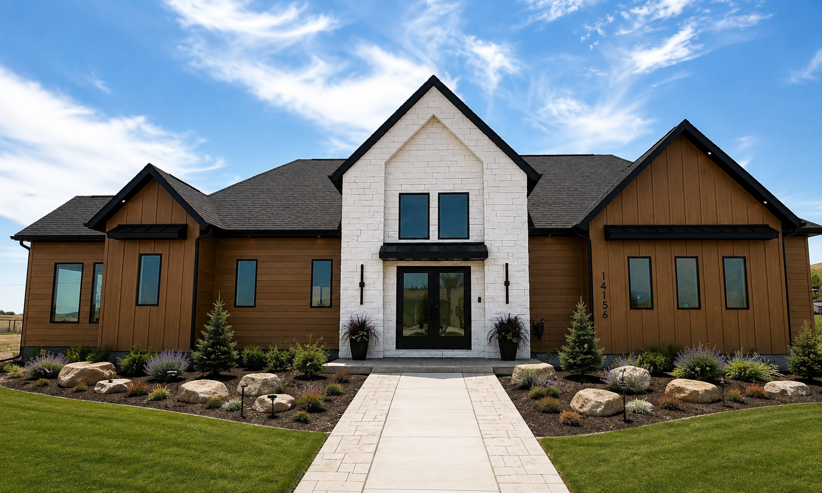 Front exterior of 14156 Saddle Hill Drive with stone entry gable, cedar siding, black roof and landscaped walkway