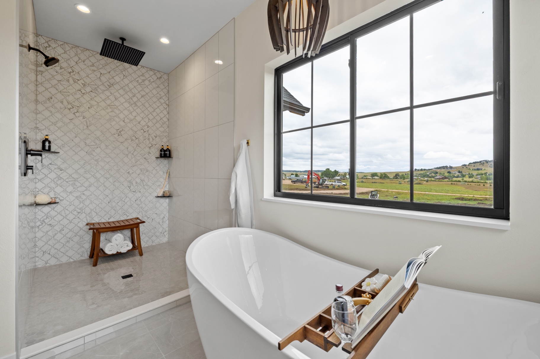 Primary bath with arabesque tiled walk-in shower, rain head and freestanding soaking tub