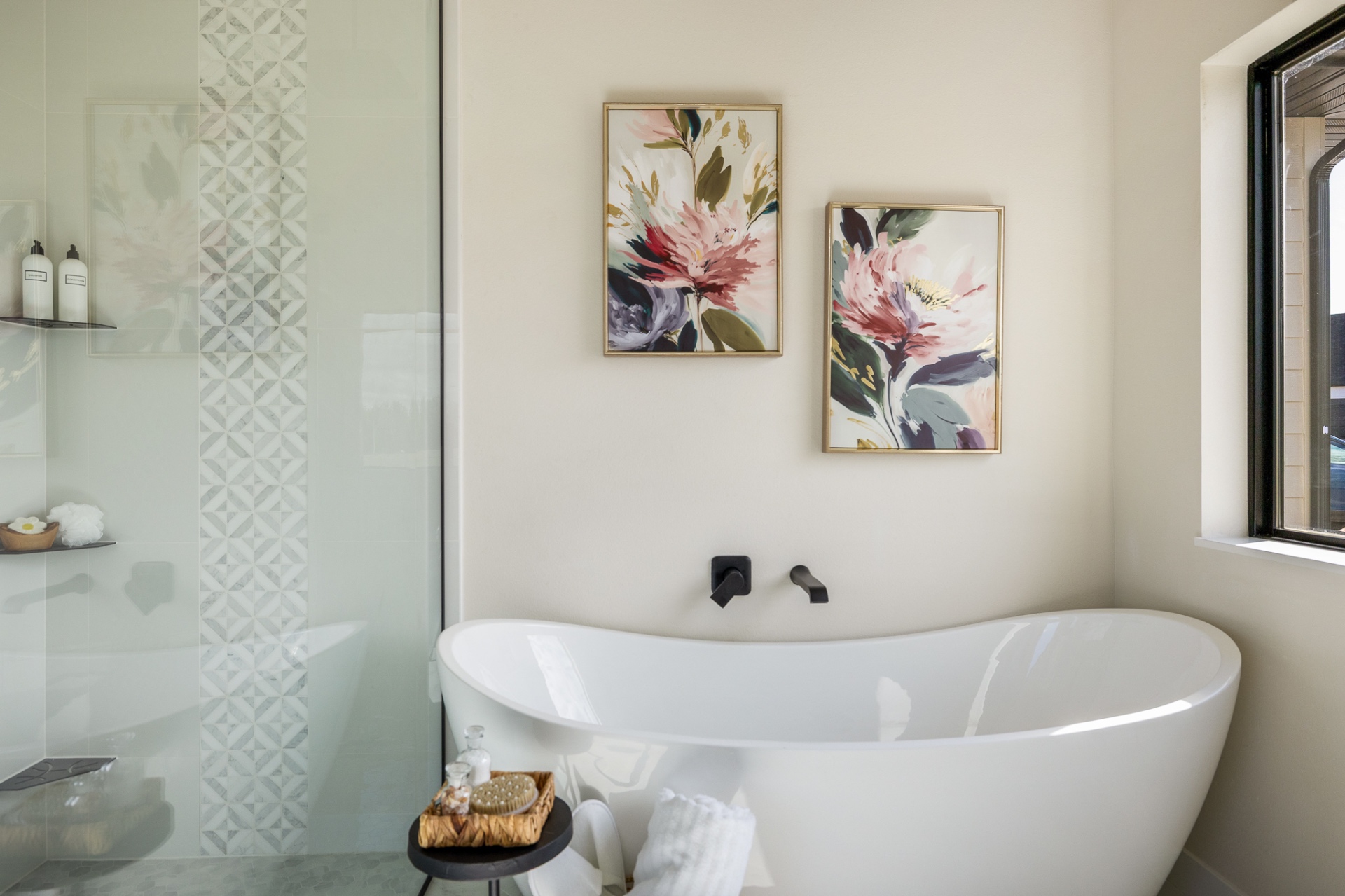 Primary bath with freestanding soaking tub, matte black fittings and tiled shower