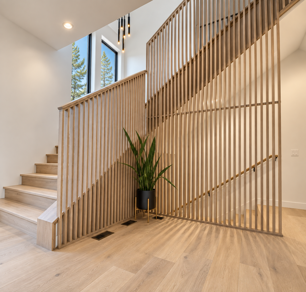 Entry stair with white oak slat railing, black framed windows and a modern pendant light