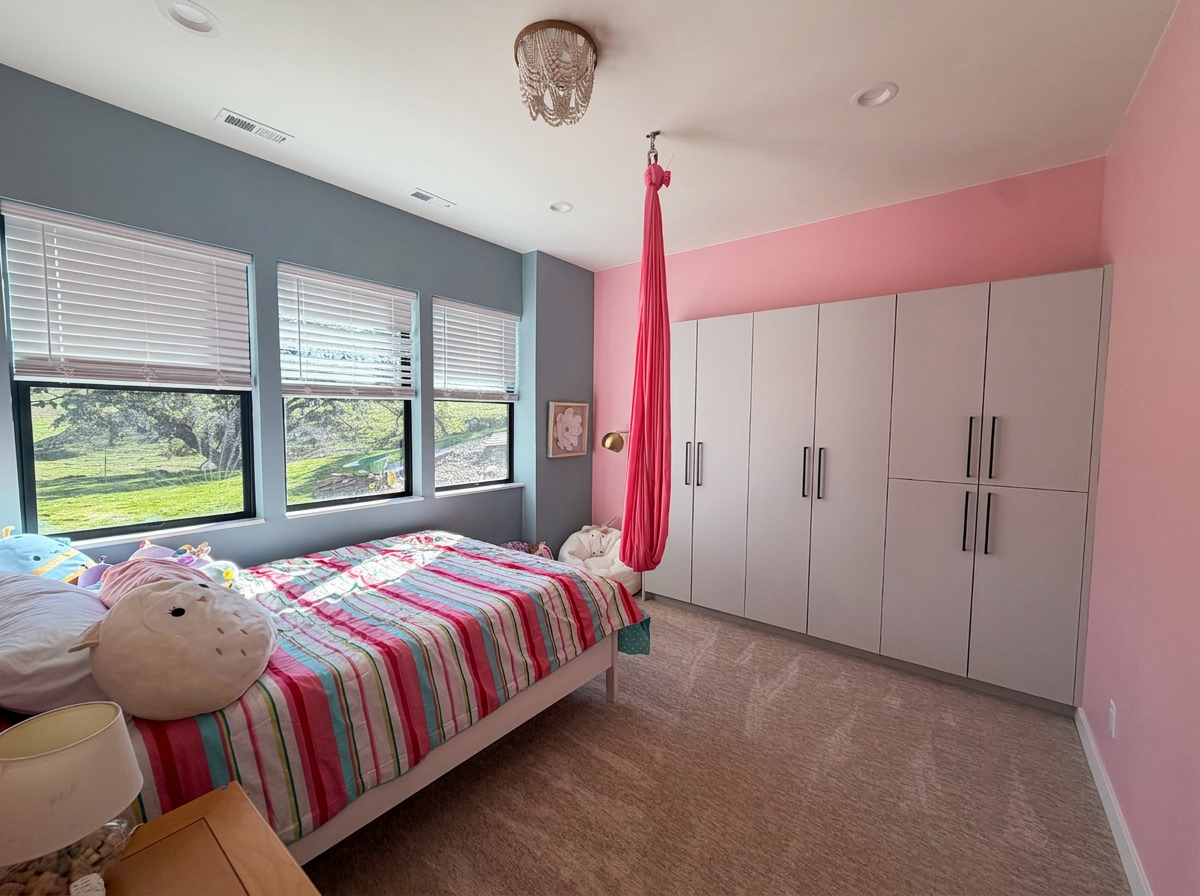 Bedroom with color blocked walls, a full wall of built in storage and an indoor aerial hammock